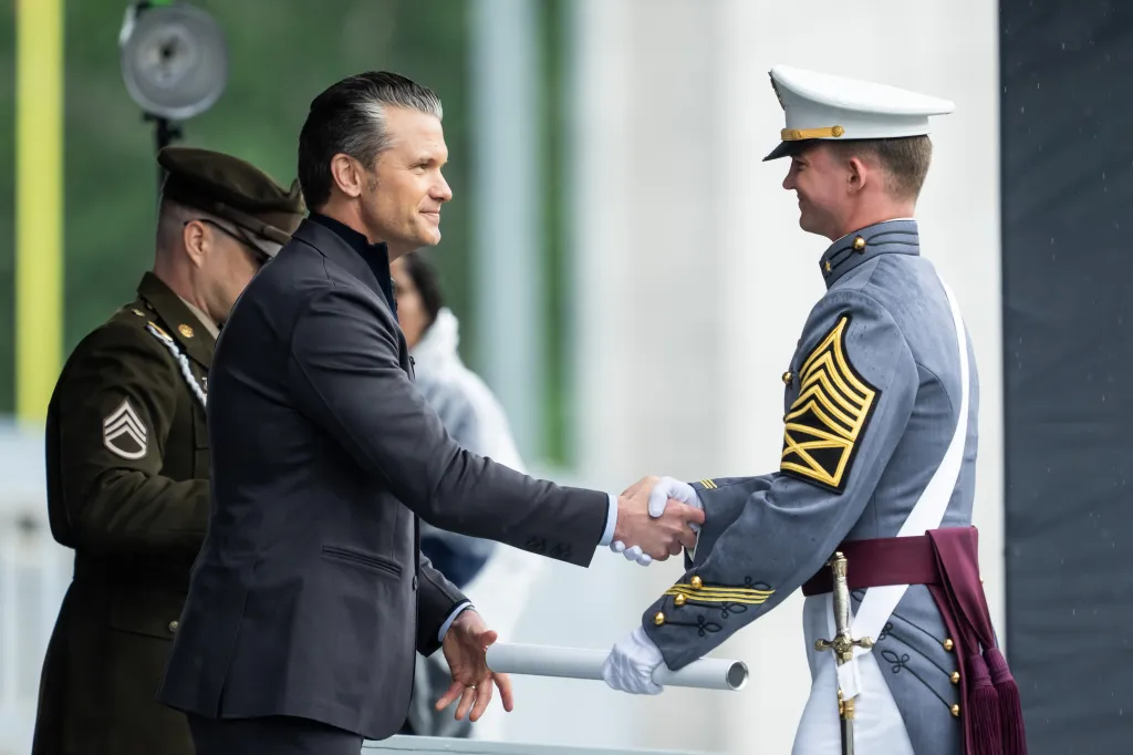 U.S. Secretary of War Pete Hegseth shakes hands with a graduating cadet at the U.S. Military Academy commencement ceremony.