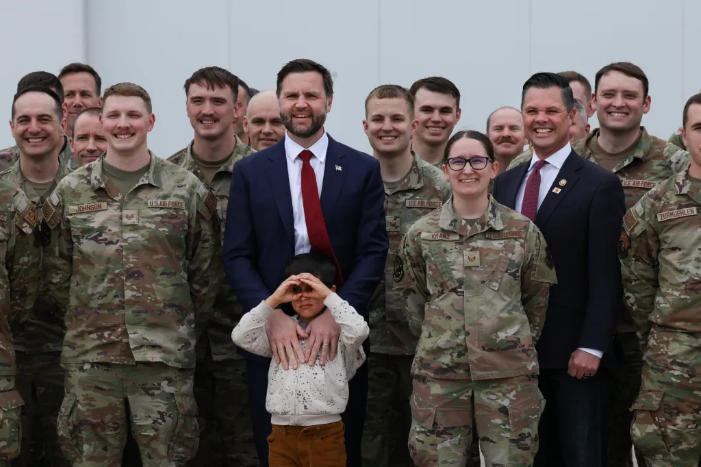 Vice President JD Vance and his son, Vivek Vance, pose for photos with U.S. Rep. Zach Nunn and members of the Iowa Air National Guard.