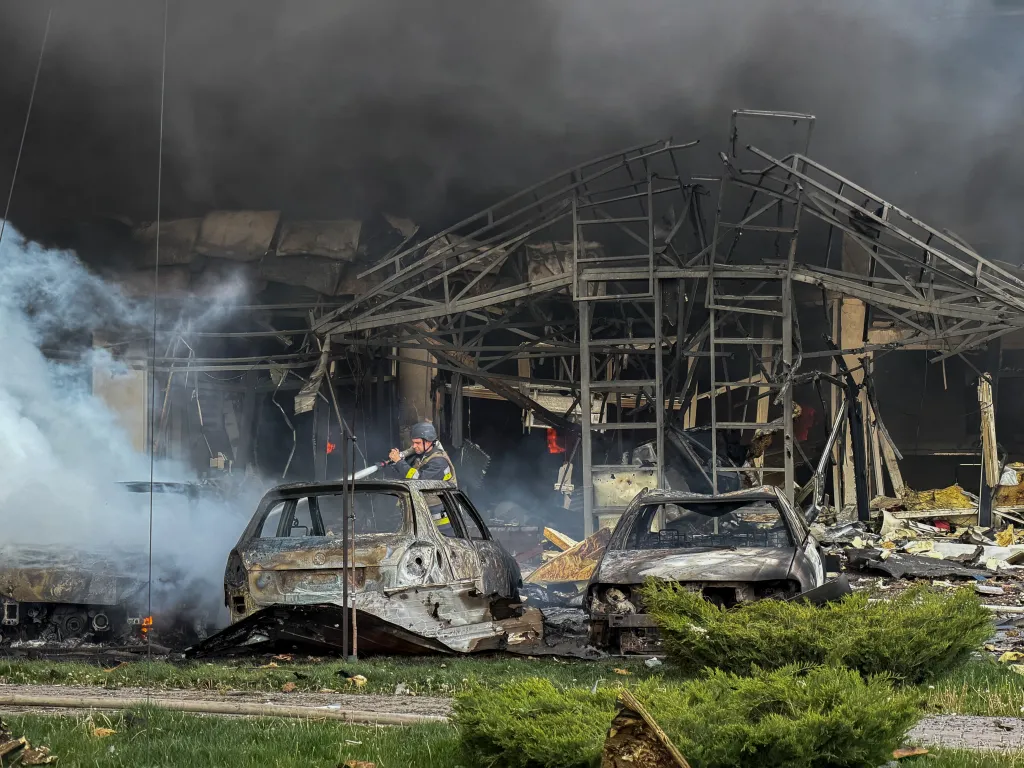 A Ukrainian rescuer puts out a fire at a building following a Russian air attack in Zaporizhzhia, Ukraine.