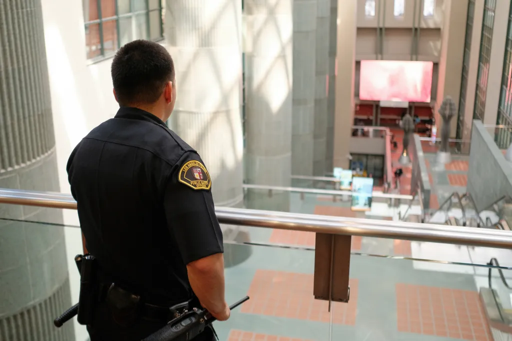 A public safety officer looks down at the Los Angeles Central Library.