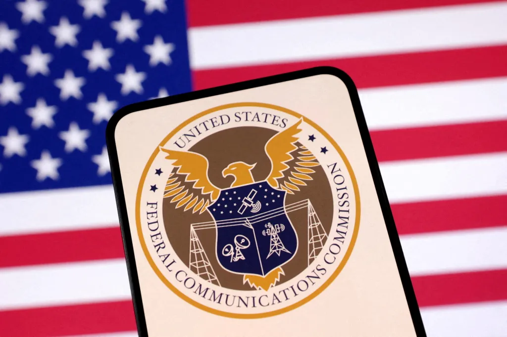 Illustration of the United States Federal Communications Commission logo on a phone in front of a U.S. flag.