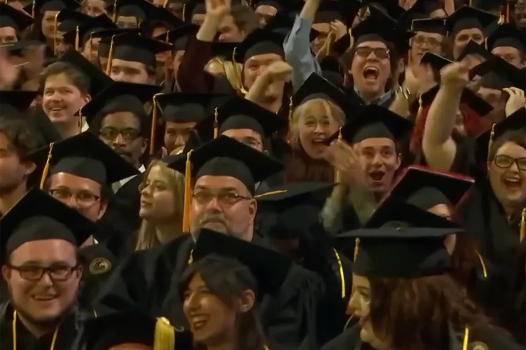 UCF graduates react during Caulfield's speech inside Addition Financial Arena in Orlando, Florida, on May 8, 2026.