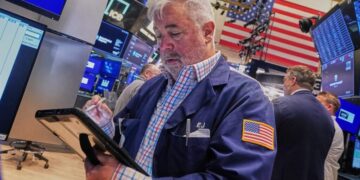 Tech carries Wall Street to records, even as most stocks fall after discouraging inflation data