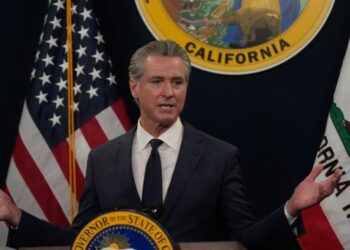 Immigrant rights advocates rally for more state healthcare funding, criticize Newsom