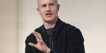 Crypto exchange Coinbase to lay off 14% of staff as AI reshapes work
