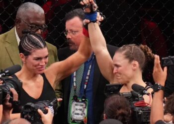 Ronda Rousey defeats Gina Carano in 17 seconds at a high-profile MMA event, retires