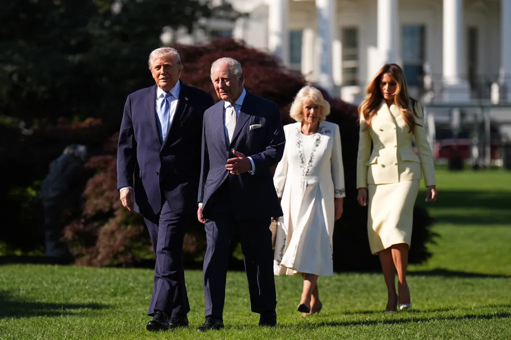 US President Donald Trump, King Charles III, Queen Camilla, and First Lady Melania Trump walk across the White House lawn.