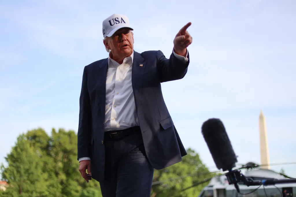 Donald Trump speaks to reporters outside the White House, gesturing with his right hand.