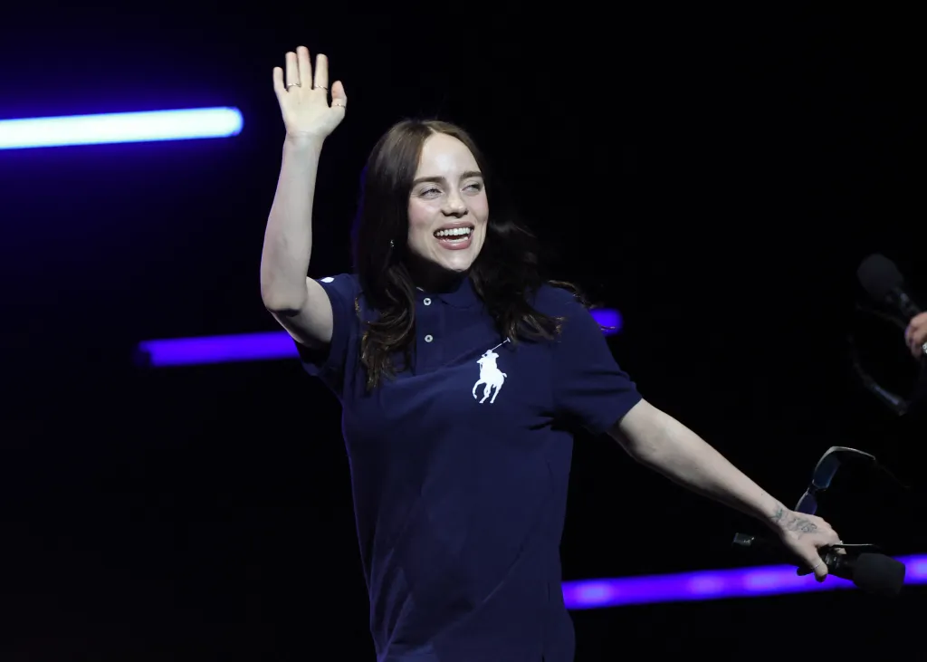 Billie Eilish waves to the audience during the Paramount Pictures presentation at CinemaCon.