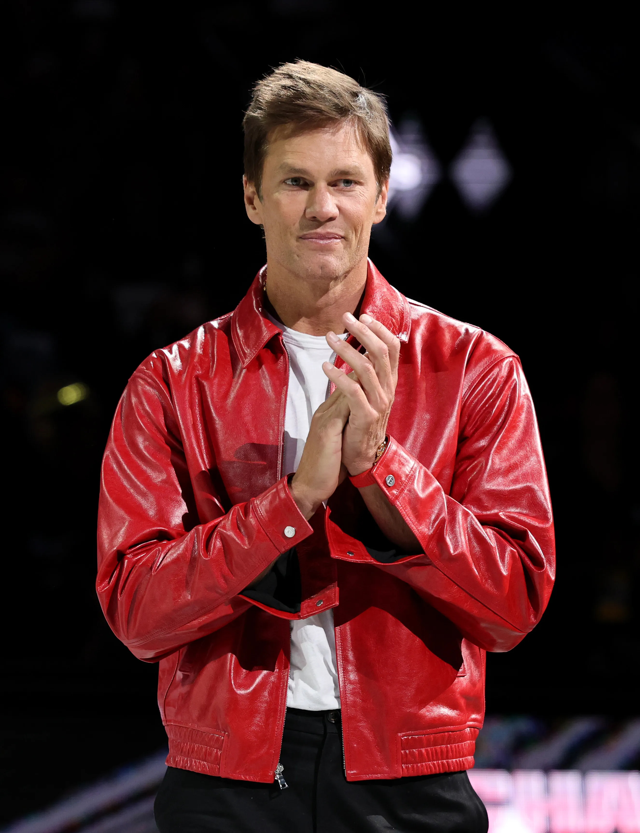 Tom Brady applauding during a championship ring ceremony.