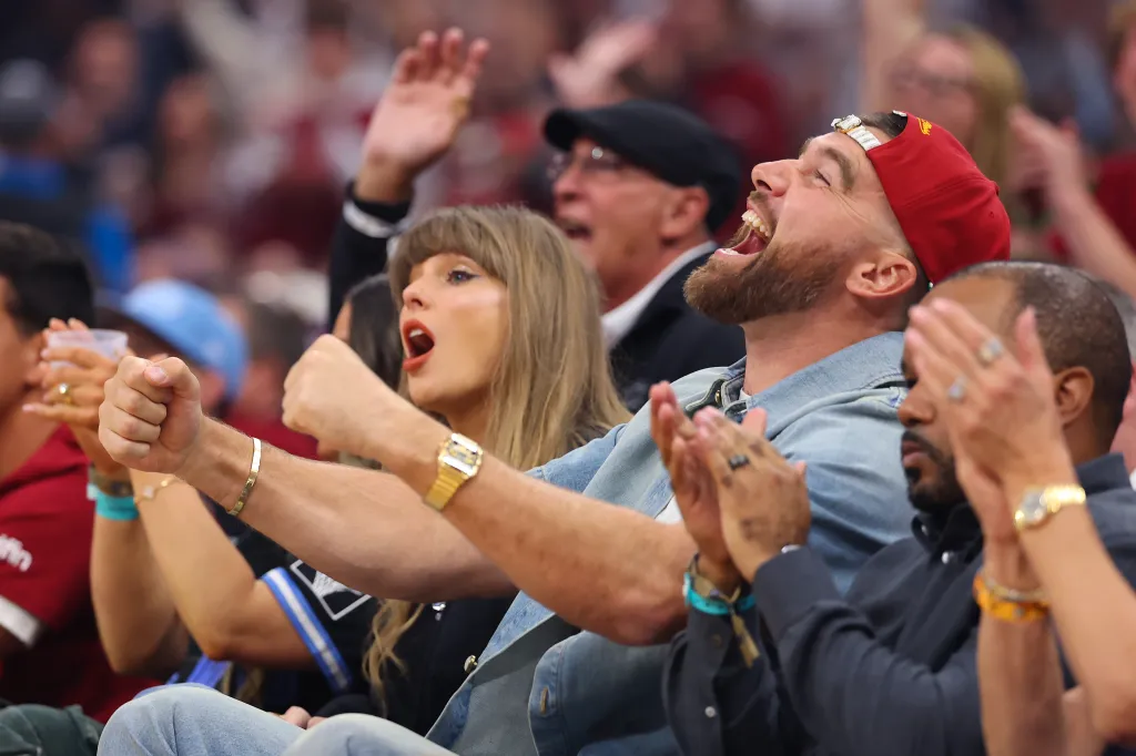 Taylor Swift and Travis Kelce cheering at an NBA game.