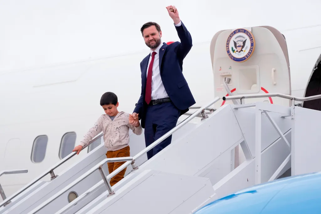 JD Vance and his son Vivek arrive at Des Moines International Airport.