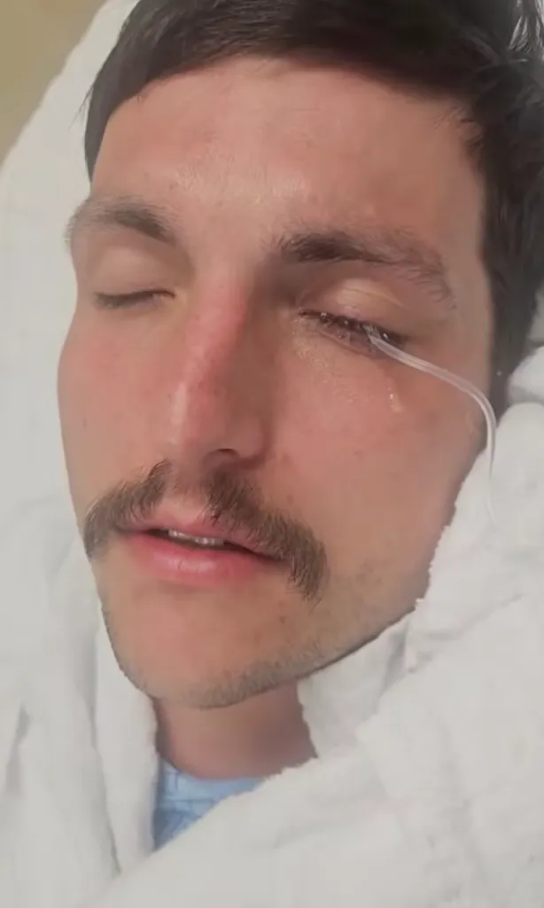 Joe Vallely receiving medical treatment with an eye tube.