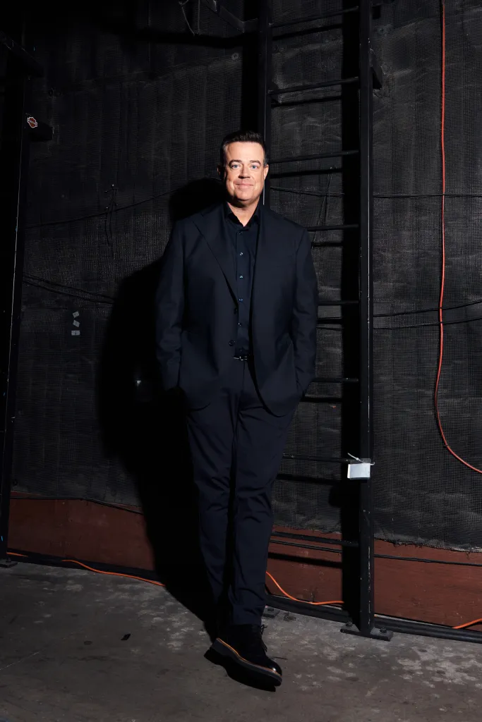 Carson Daly standing and looking at the camera.