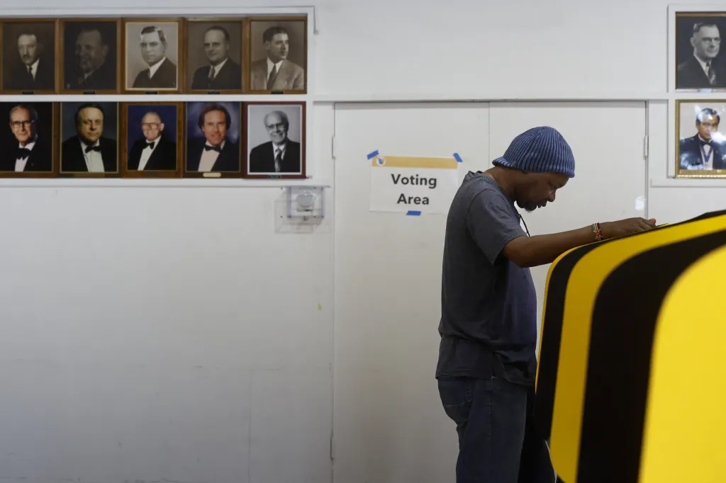 A voter casts a ballot at a voting booth during early voting.