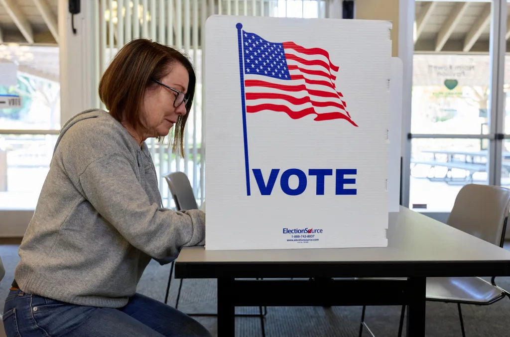A voter fills out a ballot at a polling station in California.