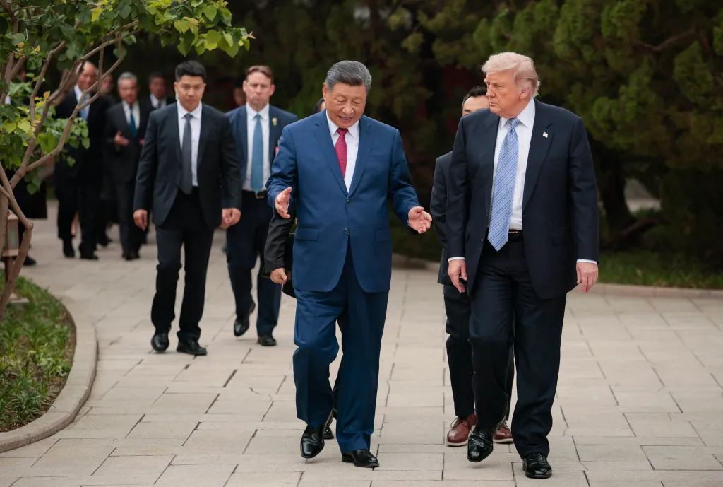 US President Donald Trump (right) walks with China's President Xi Jinping (center) after a visit to Zhongnanhai Garden in Beijing.