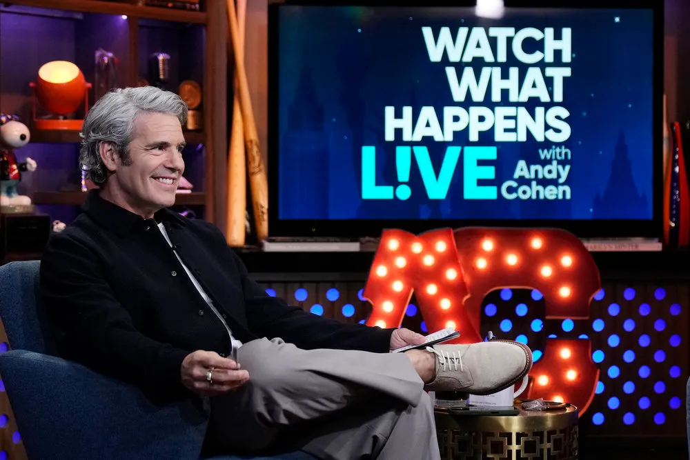 Andy Cohen seated on the set of 