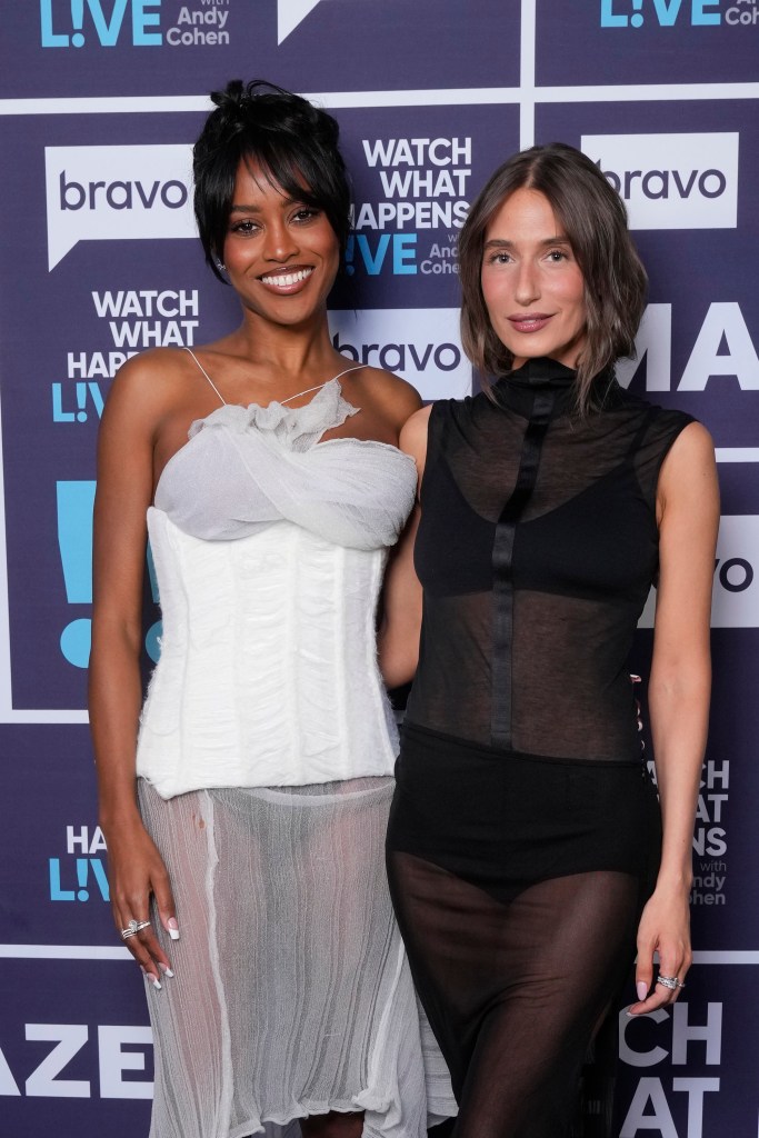 Ciara Miller and Amanda Batula standing together in front of a 