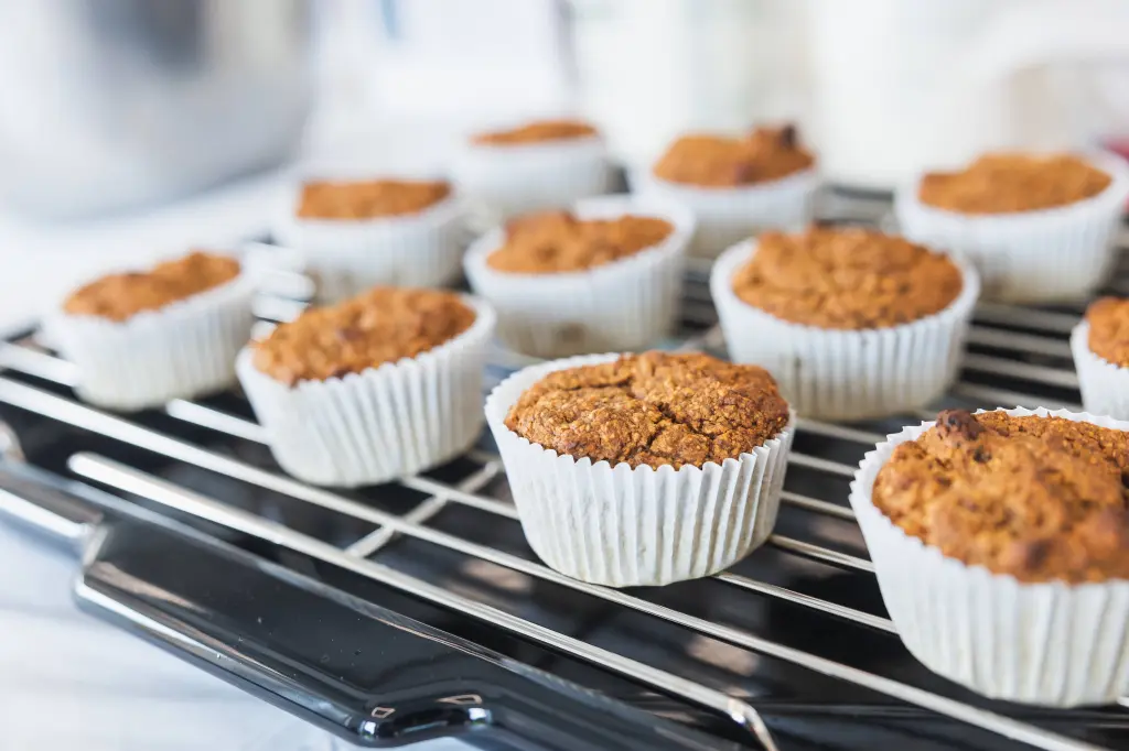 Baked muffins cooling on a rack.