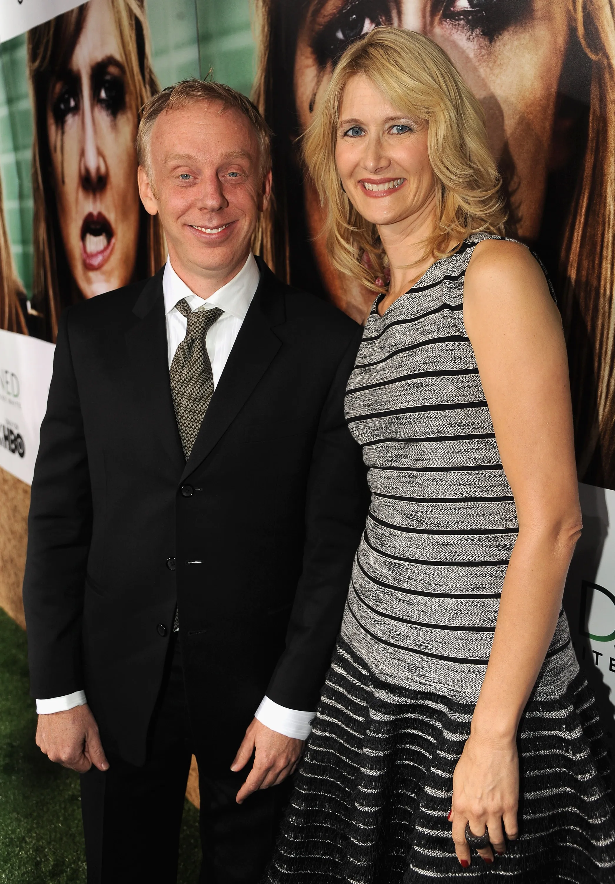 Writer-director-producer Mike White and actress Laura Dern smiling at a red carpet event.