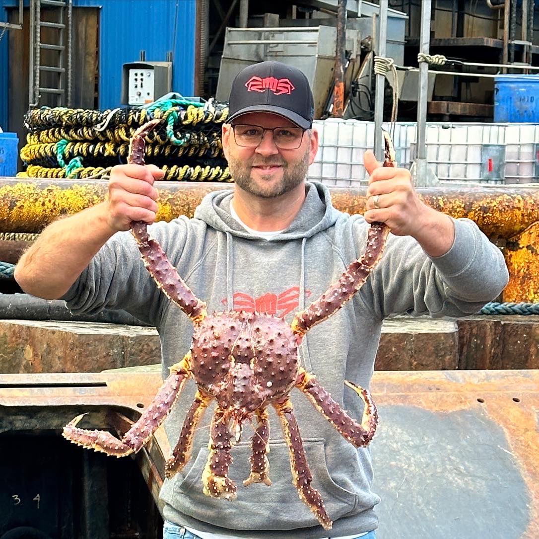 Captain Rick Shelford holding a large king crab.