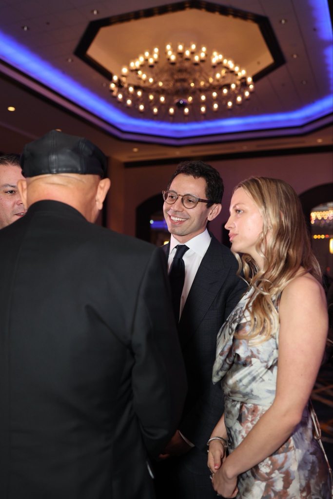 James Fishback and Francesca talking to an unidentified person.