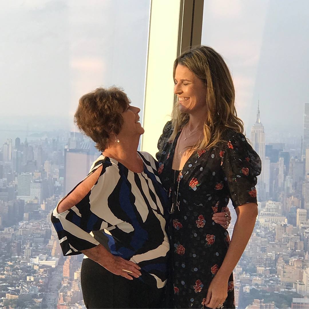 Savannah Guthrie and her mom Nancy posing for a photo with the New York City skyline in the background.