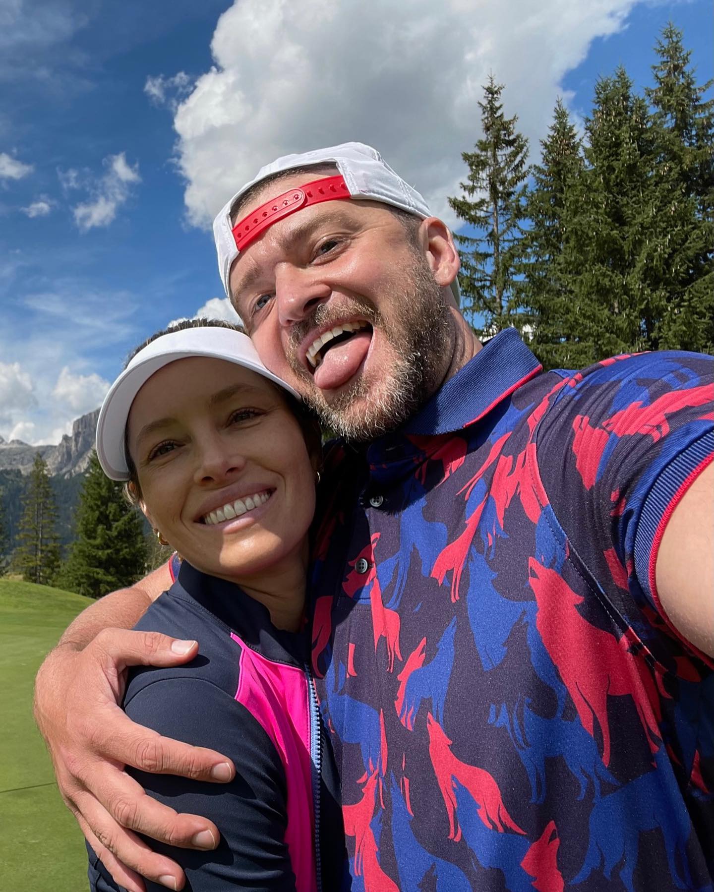 Justin Timberlake and Jessica Biel taking a selfie on a golf course.