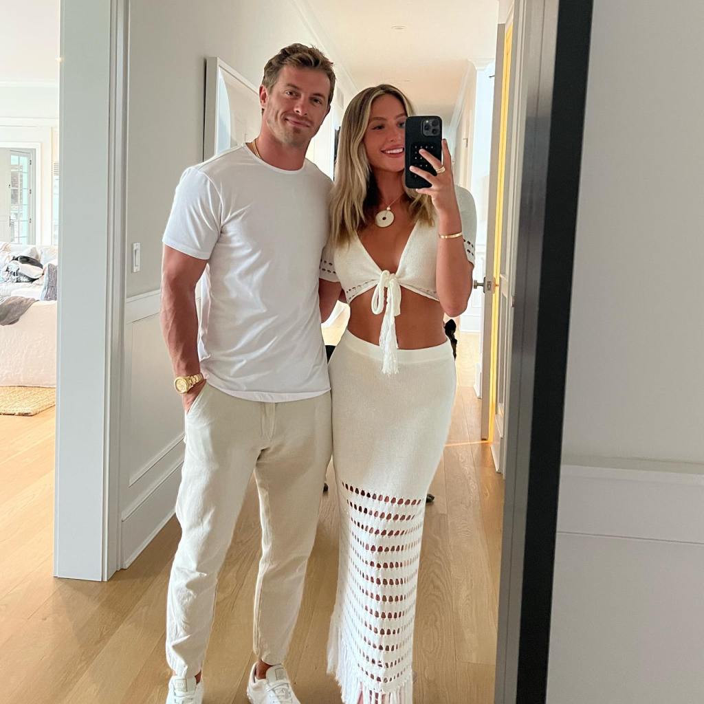 Alix Earle posing with her boyfriend, Braxton Berrios, in white outfits.