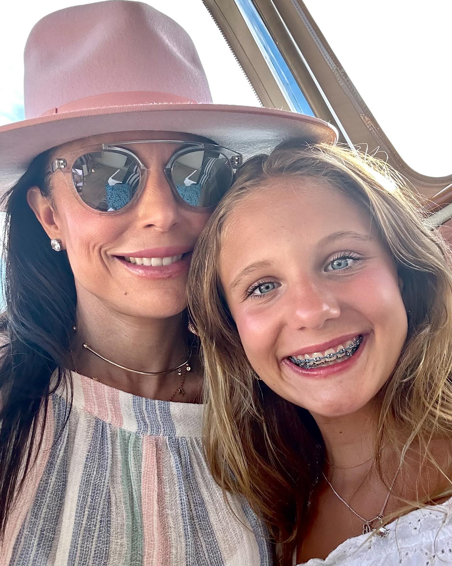 Bethenny Frankel and her daughter Bryn smiling at the camera.