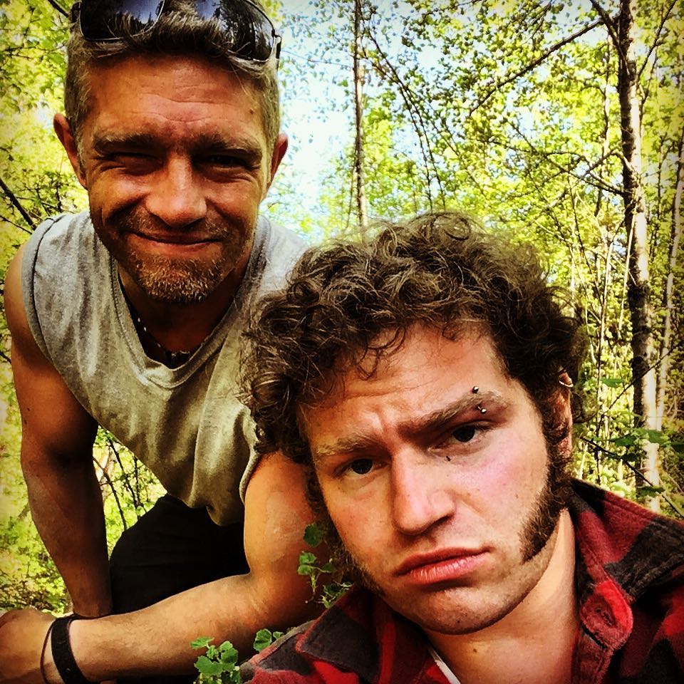 Matt Brown and Gabe Brown posing in a forest.