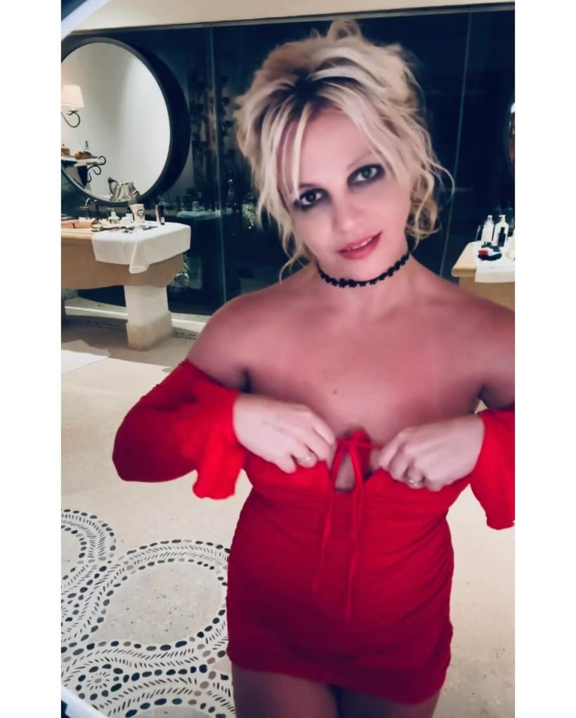 Britney Spears in a red dress with a choker.