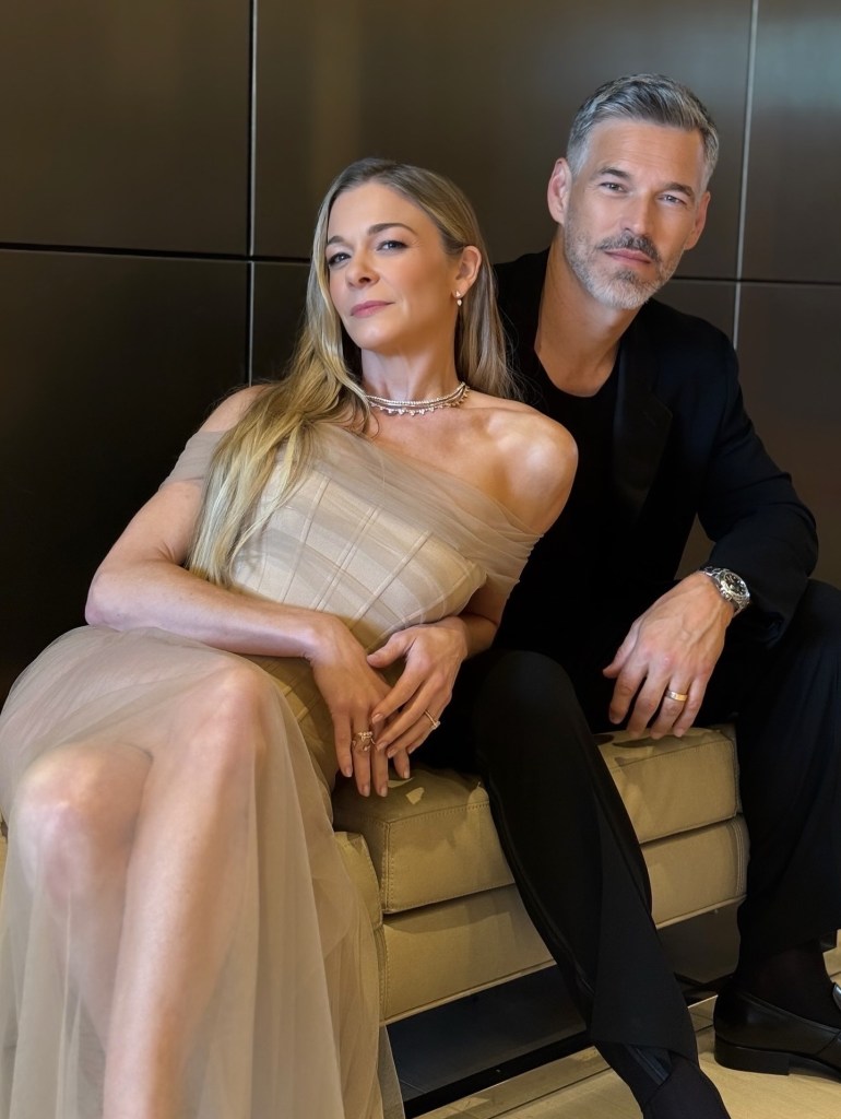 LeAnn Rimes wearing an off-the-shoulder gown and Eddie Cibrian in a black suit.