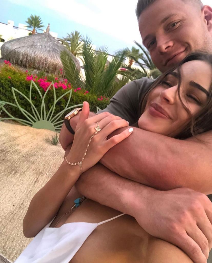 Olivia Culpo embracing a man.