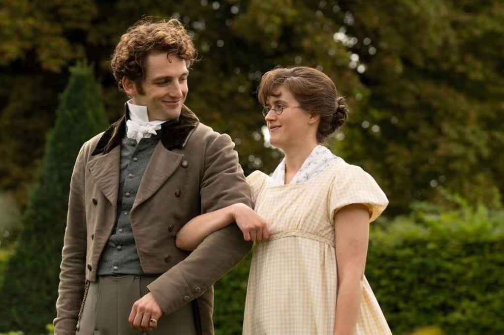 Laurie Davidson and an actress in period costumes in 