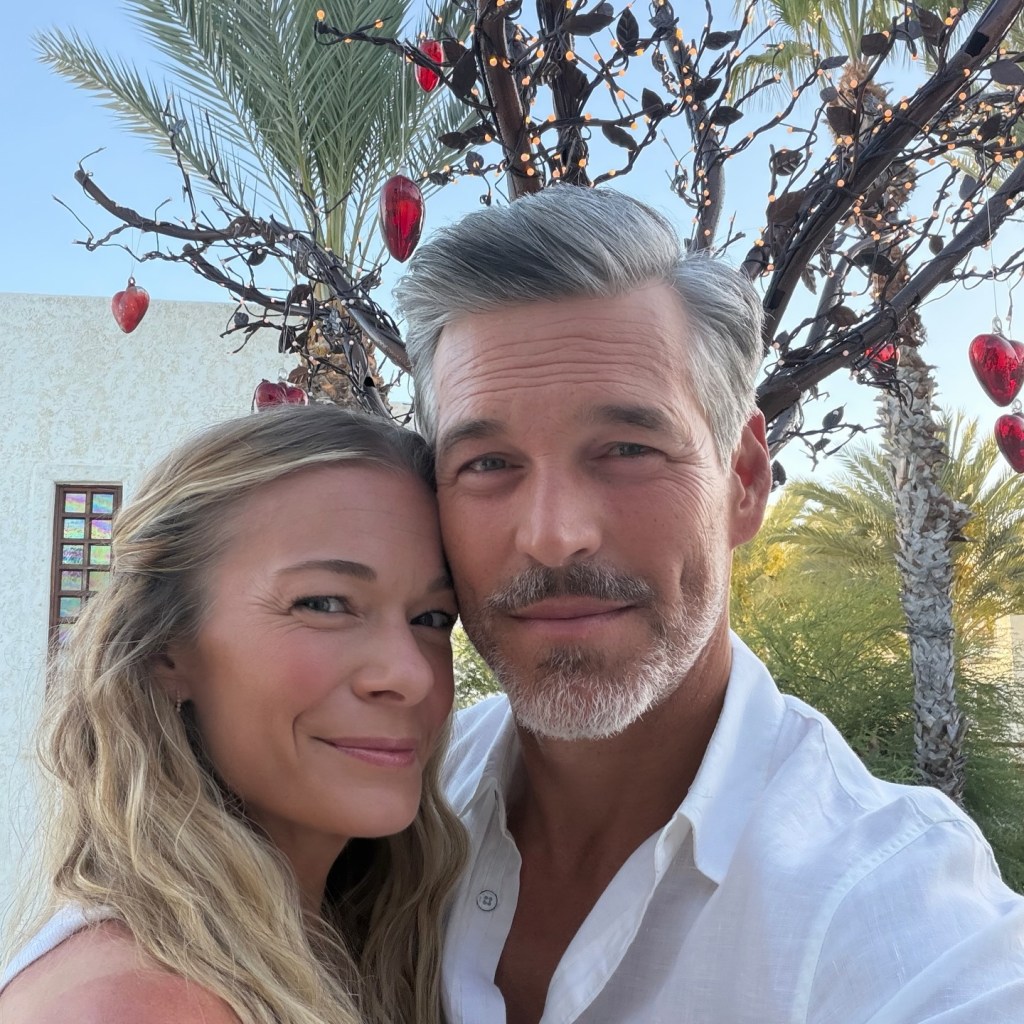Leann Rimes and Eddie Cibrian smiling for a selfie outdoors.