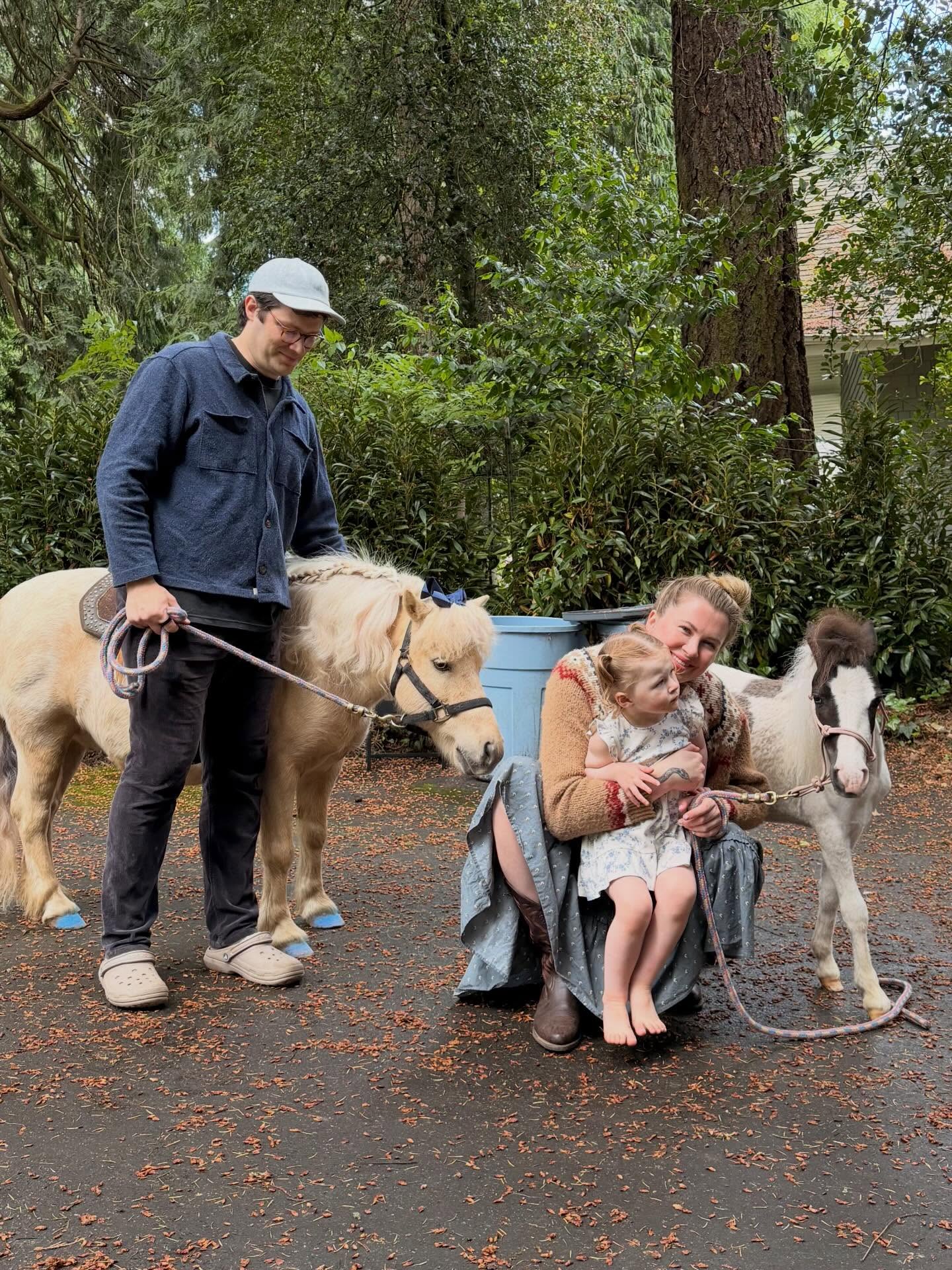 Ireland Baldwin and RAC with a child and two miniature horses.