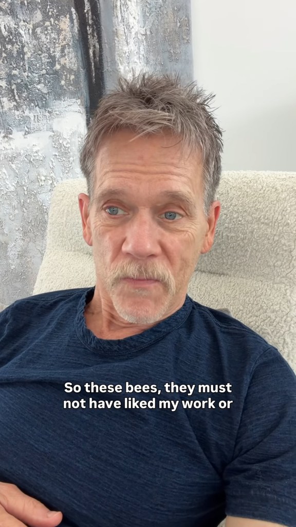 Kevin Bacon, sitting in a chair, talking about being attacked by bees.