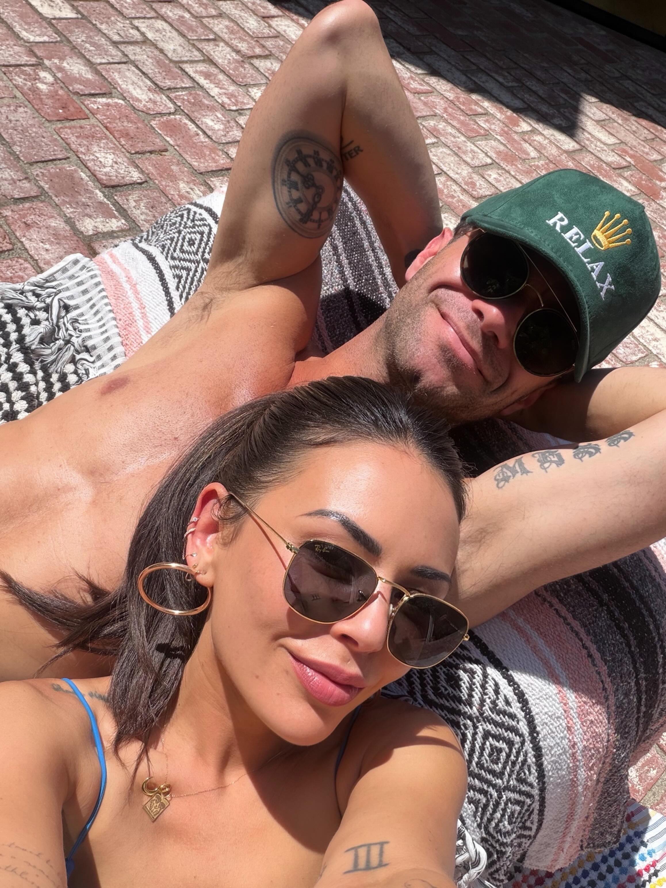 Janel Parrish and Sasha Farber relaxing in the sun.