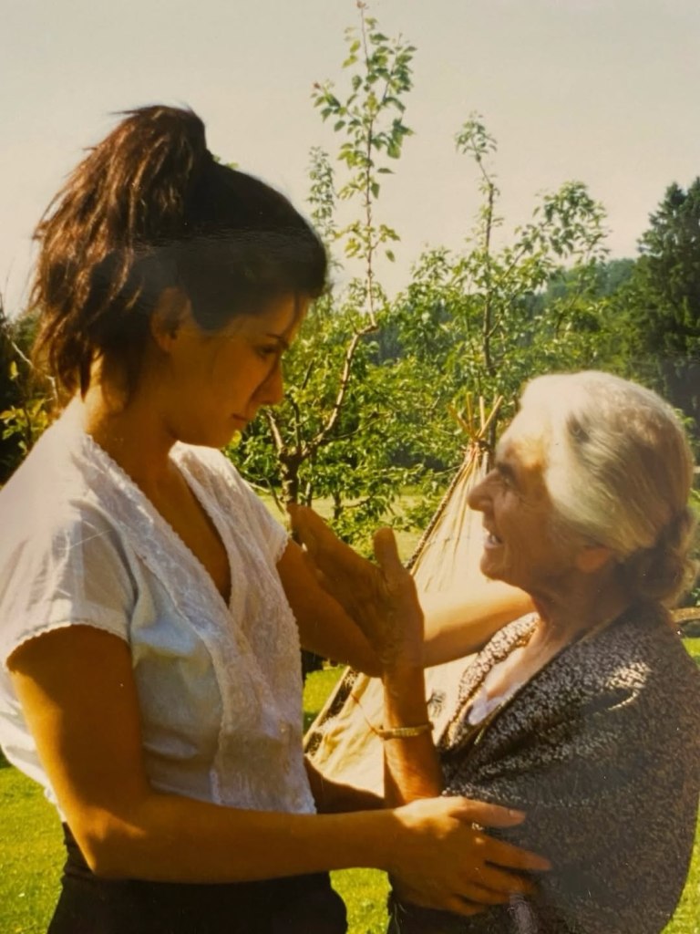 Sandra Bullock and her mother looking at each other, with Bullock's arm around her mother's waist.