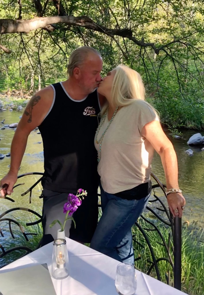 Darrell Sheets and his ex-wife Kimber kiss on a bridge over a river.