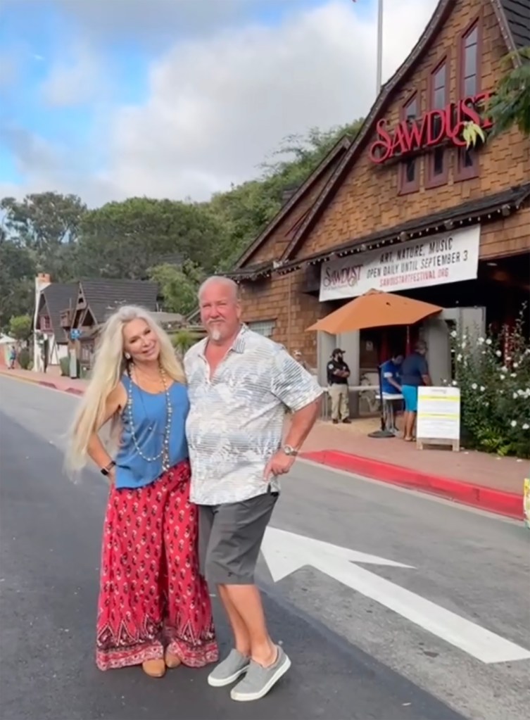 Kimber Sheets and Darrell Sheets posing in front of a building.