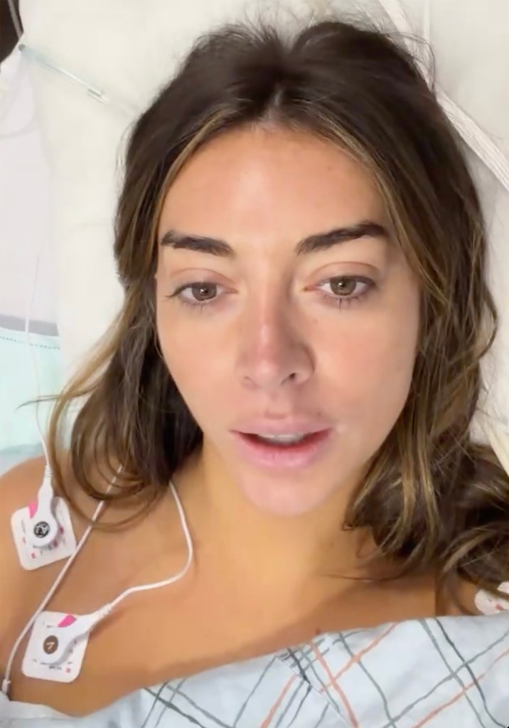 Brianna Chickenfry in a hospital bed with medical electrodes attached to her chest.