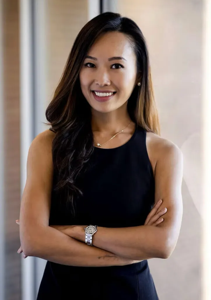 Headshot of Dr. Claudia Kim smiling with arms crossed.
