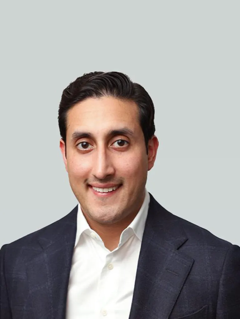 Chirayu Rana smiling slightly, wearing a dark suit jacket and white collared shirt.