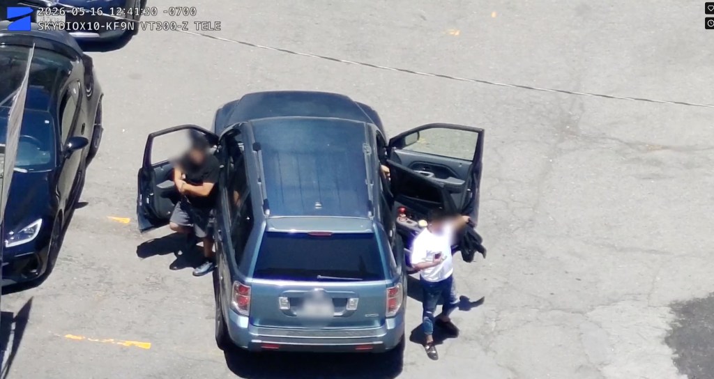 Three pickpocketing suspects getting out of their car.