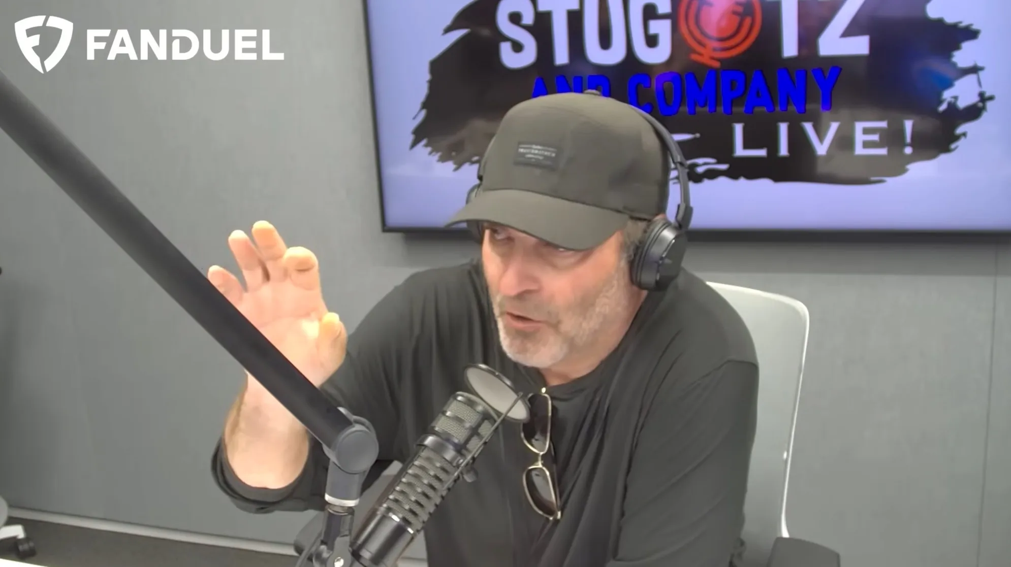 Jon Stugotz speaking into a microphone.