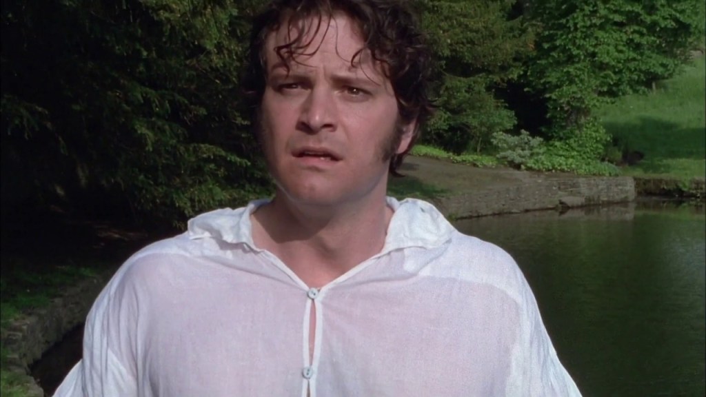 Colin Firth as Mr. Darcy in a wet shirt, standing in front of a lake.