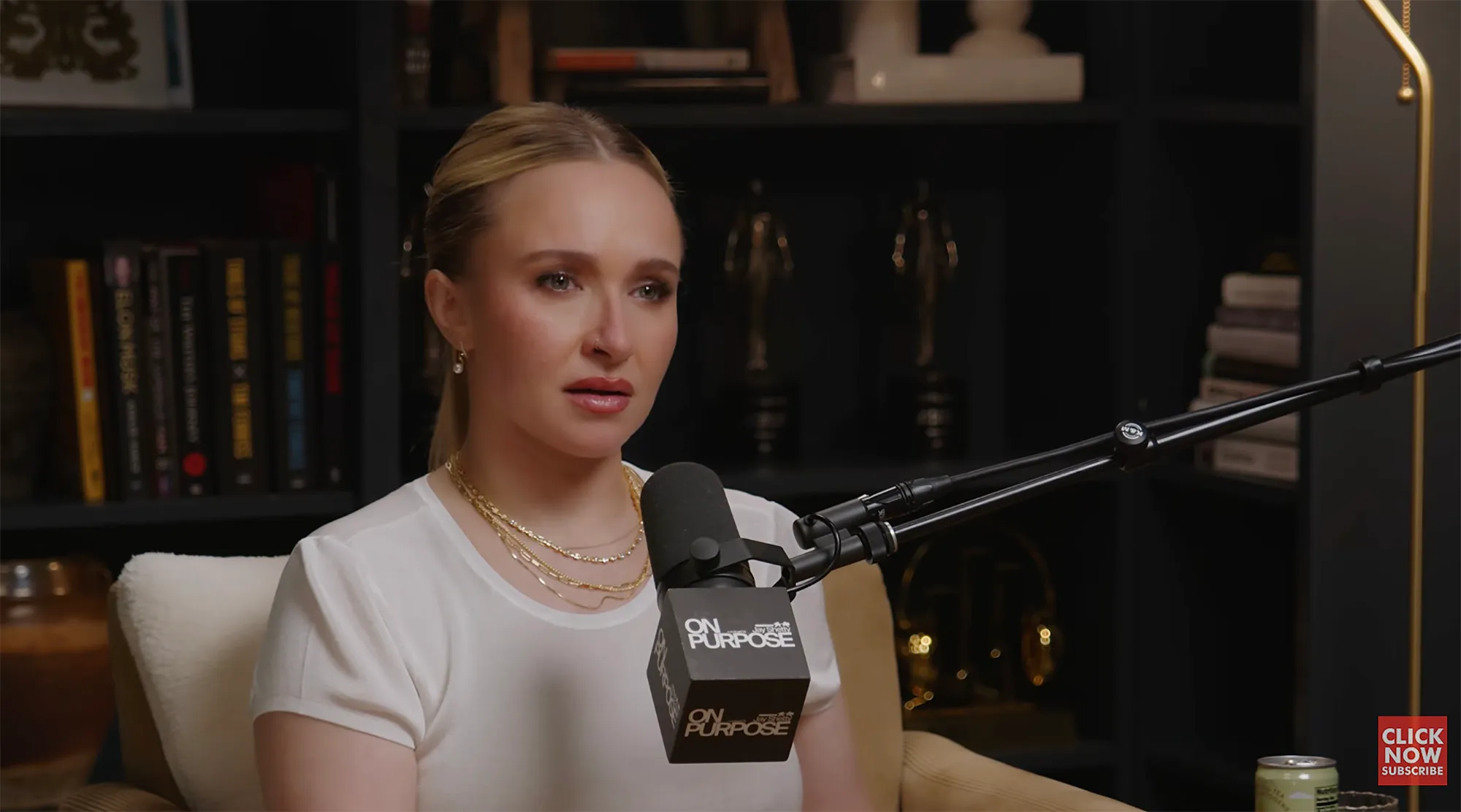 Hayden Panettiere speaking into a microphone during a podcast recording.
